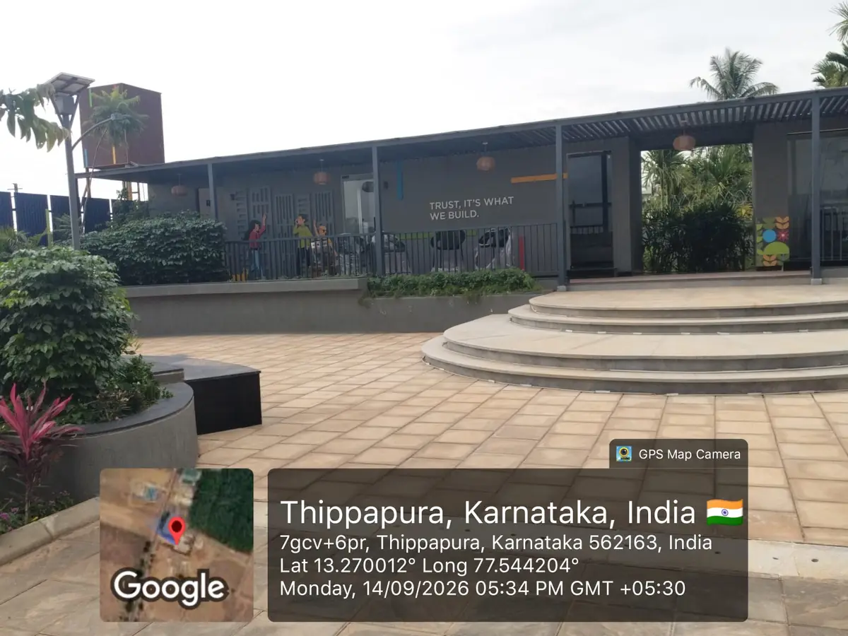 Sattva Ekatra Site Progress 14 September 2026 - Sattva marketing office with covered verandah, paved forecourt and seating steps, GPS-stamped Thippapura, Doddaballapura